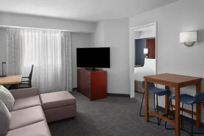 a hotel room with a couch and a tv and a table at Residence Inn by Marriott San Diego Downtown in San Diego