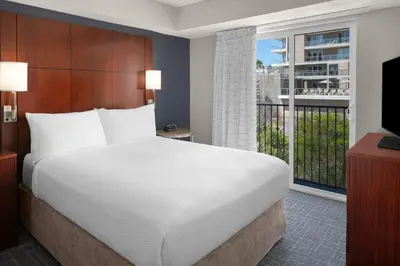 a bedroom with a large bed and a large window at Residence Inn by Marriott San Diego Downtown in San Diego