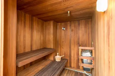 a wooden sauna with a wooden bench in it at San Clemente Cove Resort in San Clemente