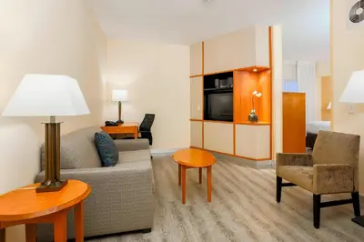 a living room with a couch and a chair and a table at Fairfield Inn & Suites Temecula in Temecula