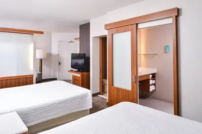 a hotel room with two beds and a television at SpringHill Suites Temecula Valley Wine Country in Temecula