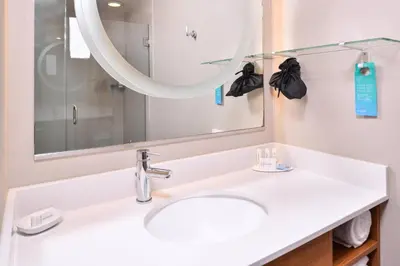 a bathroom with a sink and a mirror at SpringHill Suites Temecula Valley Wine Country in Temecula