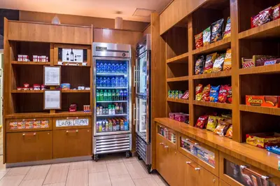 a grocery store aisle with a refrigerator at SpringHill Suites Temecula Valley Wine Country in Temecula