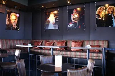 a restaurant with tables and chairs and pictures on the wall at Humphreys Half Moon Inn in San Diego