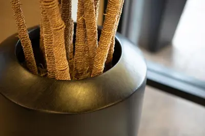 a metal vase filled with at Courtyard by Marriott San Diego Del Mar/Solana Beach in Solana Beach