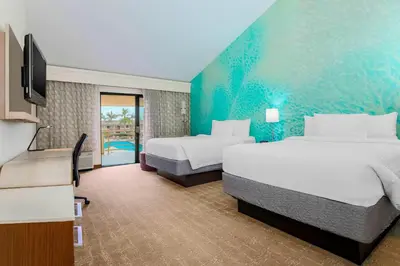 a hotel room with two beds and a television at Courtyard by Marriott San Diego Del Mar/Solana Beach in Solana Beach