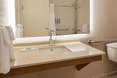 a bathroom with a white sink and a mirror at Courtyard by Marriott San Diego Del Mar/Solana Beach in Solana Beach