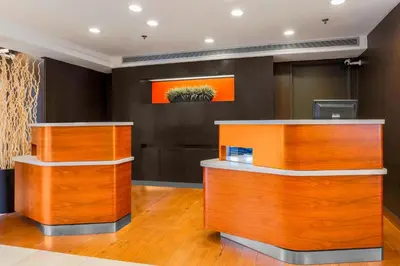 a lobby with wooden cabinets and a cactus painting on the wall at Courtyard by Marriott San Diego Del Mar/Solana Beach in Solana Beach