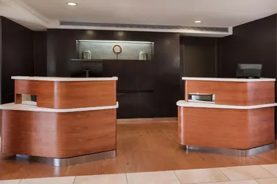 a salon with wooden counters and a mirror at Courtyard by Marriott San Diego Del Mar/Solana Beach in Solana Beach
