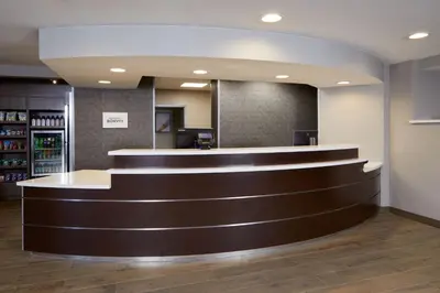a lobby of a pharmacy with a brown counter top at Residence Inn San Diego Carlsbad in Carlsbad