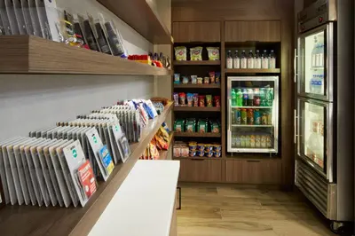a grocery store aisle with a refrigerator and drinks at Residence Inn San Diego Carlsbad in Carlsbad