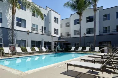 a swimming pool with lounge chairs and a hotel at Residence Inn San Diego Carlsbad in Carlsbad