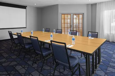 a conference room with a long wooden table and chairs at Courtyard by Marriott San Diego Rancho Bernardo in Rancho Bernardo
