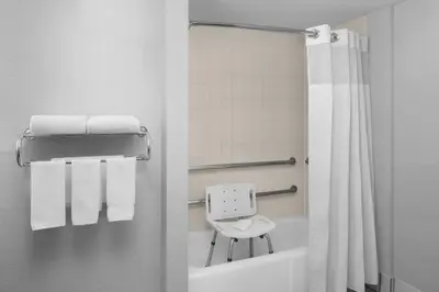a bathroom with a shower curtain and a white tub at Courtyard by Marriott San Diego Rancho Bernardo in Rancho Bernardo