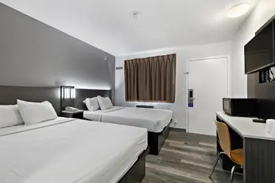 a hotel room with two beds and a television at Motel 6-Oceanside, CA in Oceanside