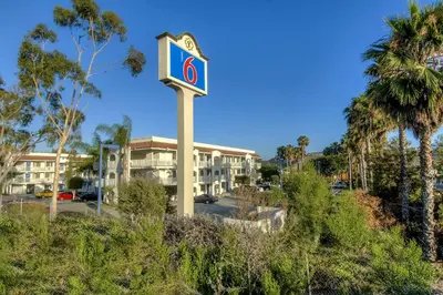 a sign in front of a parking lot with a building at Motel 6-Oceanside, CA in Oceanside