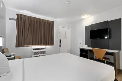 a hotel room with a large bed and a desk at Motel 6-Oceanside, CA in Oceanside