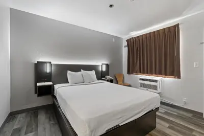 a bedroom with a large bed and a window at Motel 6-Oceanside, CA in Oceanside