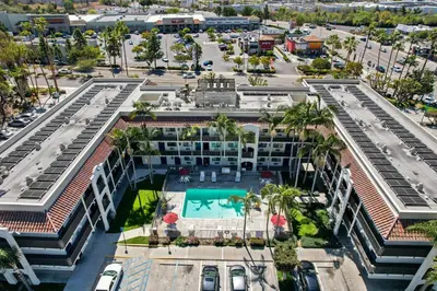 an aerial view of a building with a swimming pool at Motel 6-Oceanside, CA in Oceanside