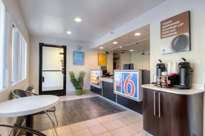 a coffee shop with a counter and a table at Motel 6-Oceanside, CA in Oceanside