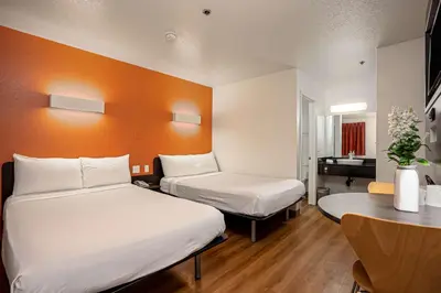 a hotel room with two beds and a table at Motel 6-Temecula, CA - Historic Old Town in Temecula