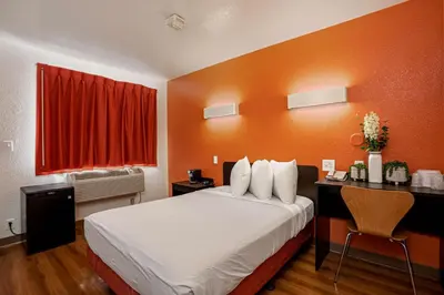 a hotel room with a bed and a desk and a window at Motel 6-Temecula, CA - Historic Old Town in Temecula
