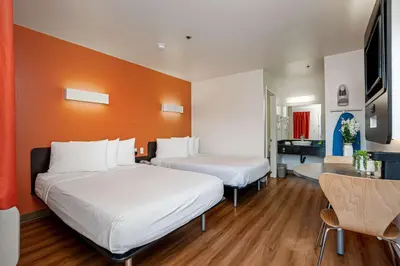 a hotel room with two beds and a desk at Motel 6-Temecula, CA - Historic Old Town in Temecula
