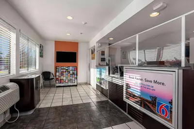 a room with a video game store with a large screen at Motel 6-Temecula, CA - Historic Old Town in Temecula
