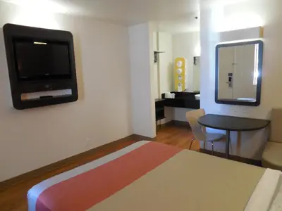a hotel room with a bed and a tv on the wall at Motel 6-Temecula, CA - Historic Old Town in Temecula