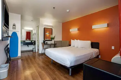 a hotel room with a large bed and a desk at Motel 6-Temecula, CA - Historic Old Town in Temecula