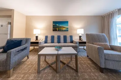 a living room with two chairs and a couch and a table at Southern California Beach Club in Oceanside