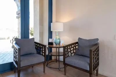 a room with two chairs and a table with a lamp at Southern California Beach Club in Oceanside