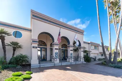 a building with two american flags in front of it at Southern California Beach Club in Oceanside