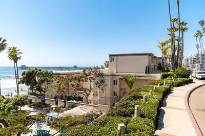 a view of a building and the beach at Southern California Beach Club in Oceanside