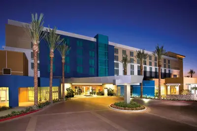 a building with palm trees in front of it at Renaissance ClubSport Aliso Viejo Laguna Beach Hotel in Aliso Viejo