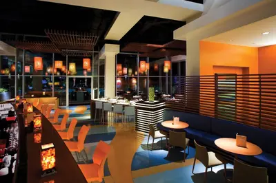 a restaurant with tables and chairs and a bar at Renaissance ClubSport Aliso Viejo Laguna Beach Hotel in Aliso Viejo
