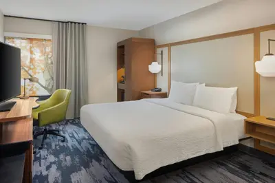 a hotel room with a bed and a desk and a television at Fairfield by Marriott Mission Viejo Orange County in Mission Viejo