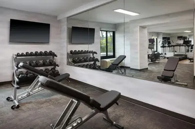 a fitness room with a large mirror and equipment at Fairfield by Marriott Mission Viejo Orange County in Mission Viejo