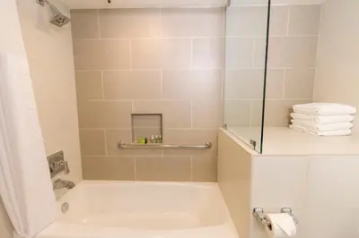 a bathroom with a white tub and a shower at Carlsbad Seapointe Resort in Carlsbad