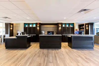 a woman standing at a counter in an office at Carlsbad Seapointe Resort in Carlsbad
