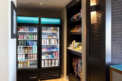 a kitchen with a refrigerator with food and drinks at Carlsbad Seapointe Resort in Carlsbad
