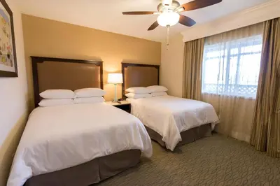 a hotel room with two beds and a ceiling fan at Carlsbad Seapointe Resort in Carlsbad