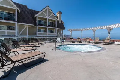 a resort with a pool with chairs and a gazebo at Carlsbad Inn Beach Resort in Carlsbad