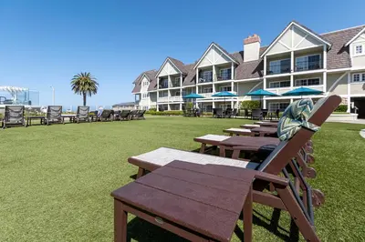 a group of tables and chairs in front of a building at Carlsbad Inn Beach Resort in Carlsbad