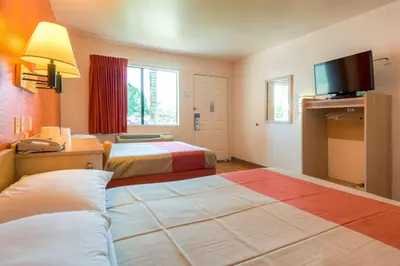 a hotel room with two beds and a flat screen tv at Motel 6-El Cajon, CA - San Diego in El Cajon