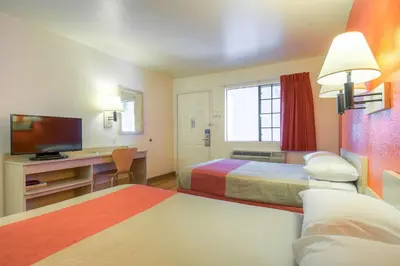 a hotel room with two beds and a television at Motel 6-El Cajon, CA - San Diego in El Cajon