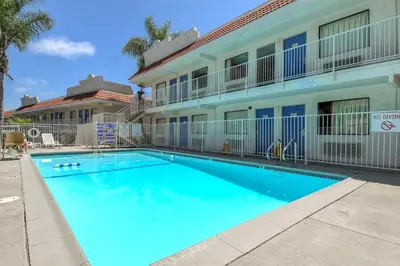 a swimming pool in front of a building at Motel 6-Carlsbad, CA - East Near LEGOLAND in Carlsbad