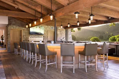 a bar in a restaurant with chairs and a counter at The Ranch at Laguna Beach in Laguna Beach