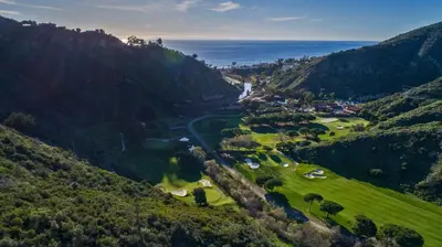 an aerial view of a golf course in the mountains at The Ranch at Laguna Beach in Laguna Beach