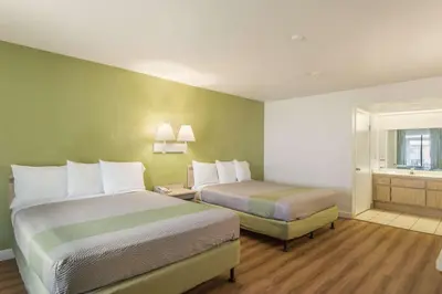 a hotel room with two beds and a window at Motel 6 Hemet in Hemet